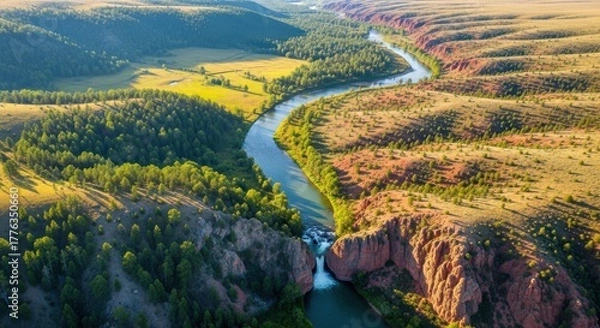 Obraz Aerial view of a winding river through a dramatic canyon landscape