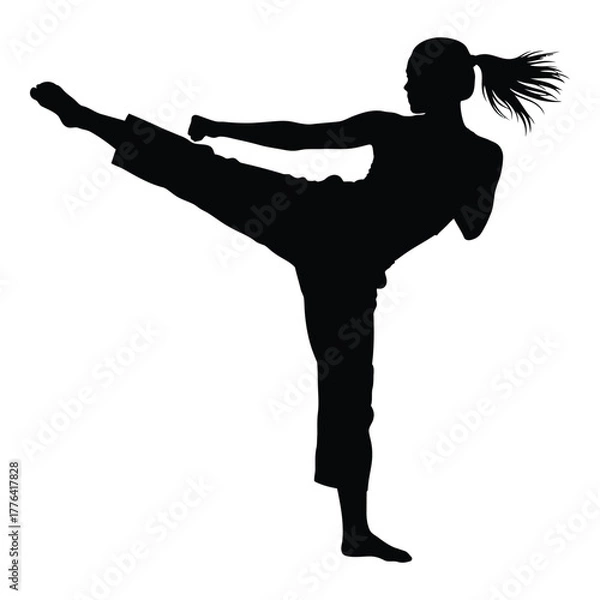 Fototapeta Female martial artist silhouette performing a powerful, dynamic high kick in a training or combat scenario, showcasing strength, agility, and self-defense discipline.