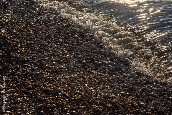 Obraz Glossy gravel and ionian sea in the sunset, Greece
