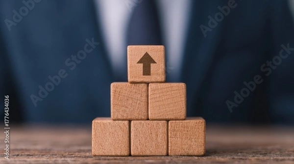 Fototapeta Building success person stacking wooden blocks with upward arrow icons in a business environment