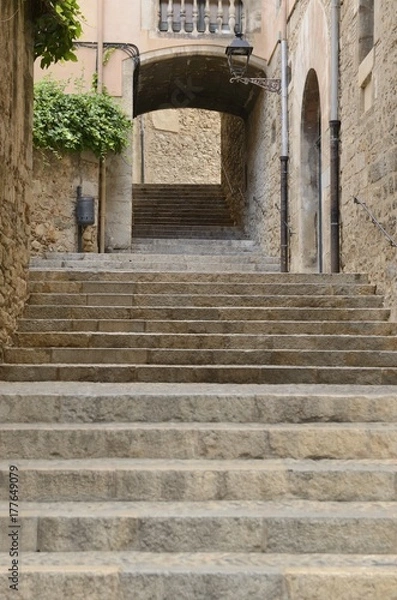 Fototapeta Stone stairs under  archway in Girona, Spain