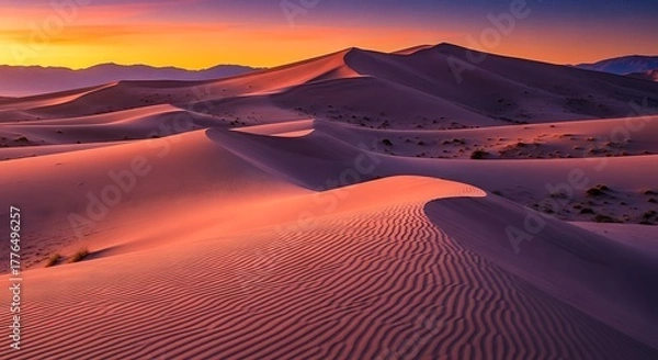 Fototapeta Majestic desert landscape with undulating sand dunes, vibrant sunset hues, and distant mountains creating a serene natural vista.
