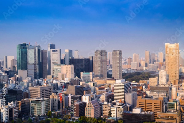 Fototapeta Aerial skyscraper view of office building and downtown and cityscapes of Tokyo city with blue sly and clouds background. Japan, Asia