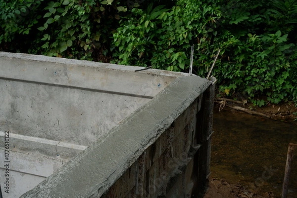 Fototapeta Reinforcement Steel Rebar Cage and Concrete Wall Foundation during Construction. Structural Engineering Detail.