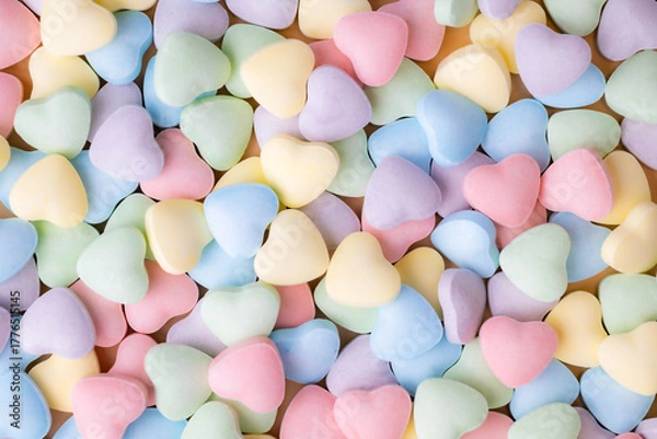 Fototapeta Blank, pastel, heart-shaped candy hearts for a colorful, festive Valentine's Day background for love note or marketing message.