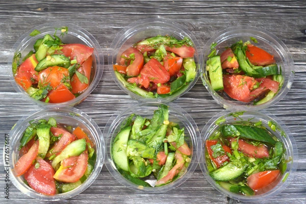 Obraz Traditional Arabic green salad with slices of cucumber, tomatoes and green arugula rocket mixed together, pieces of fresh vegetables mixed together, healthy food and dietary concept, Fresh salad