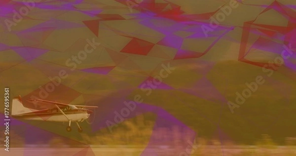 Fototapeta Flying small single-engine propeller airplane skimming grassy field, with landing gear and hillside