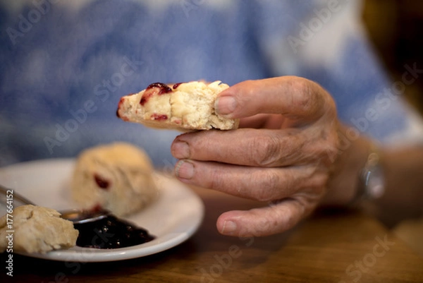 Fototapeta Homemade rustic biscuits with butter and jam in soft focus background