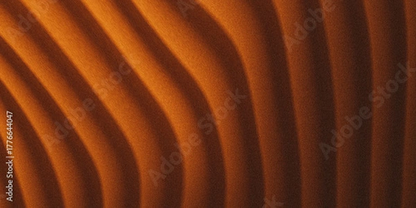 Fototapeta Abstract close-up of warm undulating sand dunes under dramatic lighting creating a textured pattern