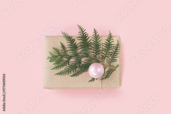 Obraz Christmas pink gift box with evergreen branches on pink background. Top view.
