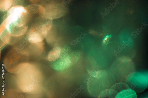 Fototapeta Bokeh effect of green and yellow colors, bright festive light photo for cover design, festive New Year background image, Christmas decoration