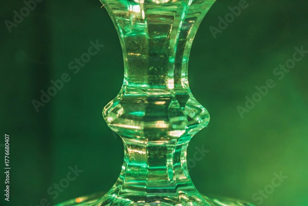 Obraz Glass stand illuminated by green light, background image close-up, futuristic light