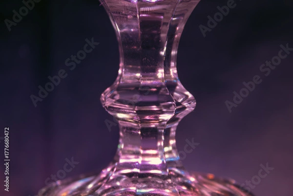 Fototapeta Glass stand illuminated by purple light, background image close-up, futuristic light