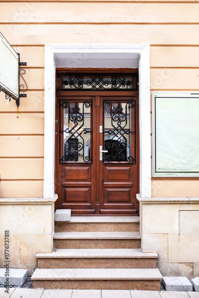 Fototapeta Designer entrance door to a country house. Modern design. Luxurious exterior. Facade of a modern building with modern doors.