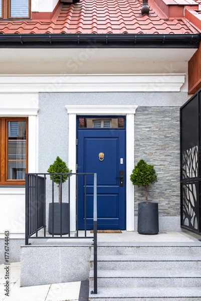 Fototapeta Designer entrance door to a country house. Modern design. Luxurious exterior. Facade of a modern building with modern doors.