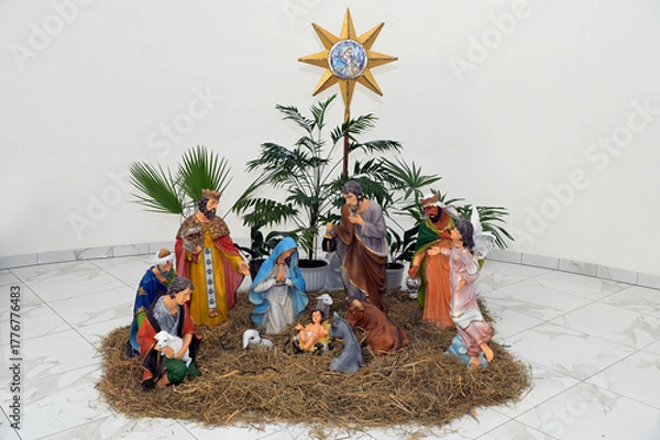 Fototapeta Traditional Christmas nativity scene represented with porcelain figurines of Mary, Joseph and baby Jesus.