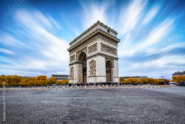 Fototapeta Long exposure day view of the Arc de Triomphe in Paris, France, during a sunny autumn day