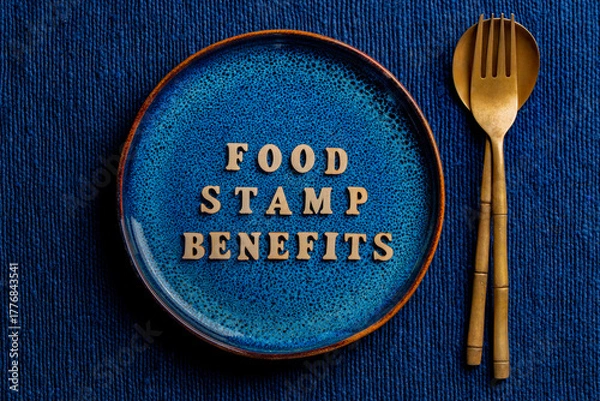 Fototapeta The inscription on the blue plate about food stamp benefits, close up. The Supplemental Nutrition Assistance Program, known as the Food Stamp Program, is a United States federal government program