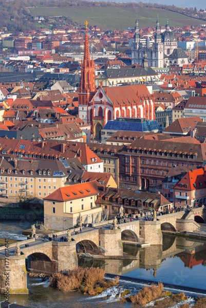 Fototapeta Historic Old Main Bridge with statues over Main River in Wurzburg, Germany with people walking across on sunny day