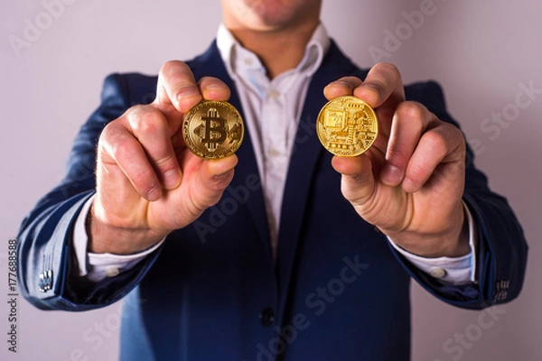 Fototapeta Golden Bitcoin in a man hand, Digitall symbol of a new virtual currency