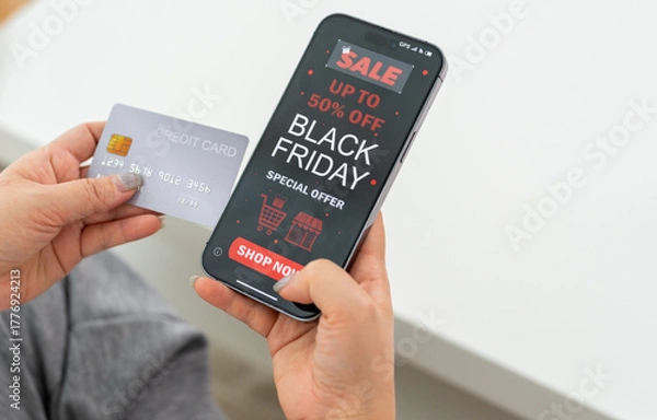 Fototapeta Person using app shop online holding smartphone with Black Friday sale ad and credit card ready for online payment, e-commerce promotions, digital marketing, online shopping and mobile transactions