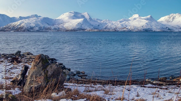 Fototapeta Snow-covered mountains and blue fjord in Arctic Tromsø, Norway