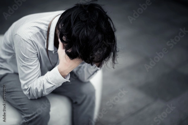 Obraz business man is stressed from his work. depression and anxiety concept.