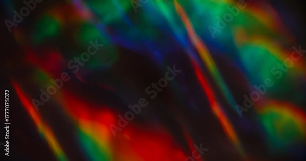 Fototapeta Lens prism defocused. Rainbow glow leak. Colorful twinkle on black background. Red green blue neon bright holographic abstract flash.