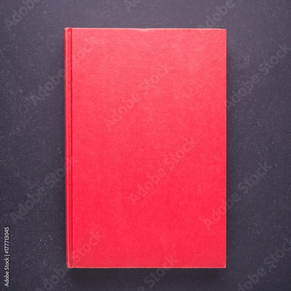 Fototapeta Red book with blank empty cover on black stone table background