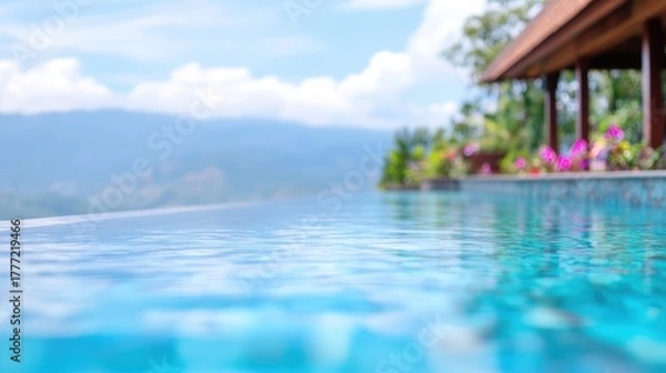 Fototapeta A serene view of a tranquil infinity pool reflecting the clear blue sky, surrounded by lush greenery and colorful flowers, perfect for promoting relaxation, vacations, or luxury retreats,