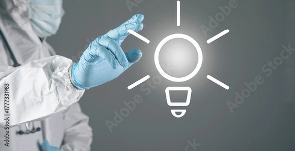 Obraz A doctor in white presses a lamp on the screen.