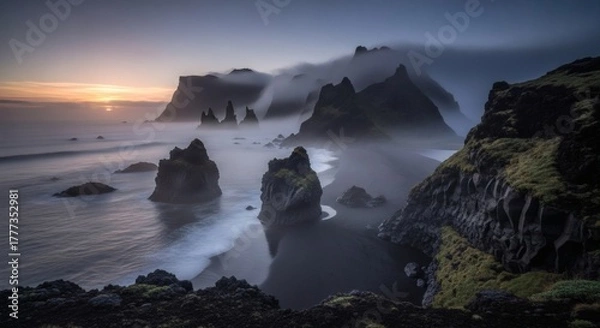 Obraz Rocky formations on a black sand beach, shrouded in fog under a dusky sky, ocean's edge