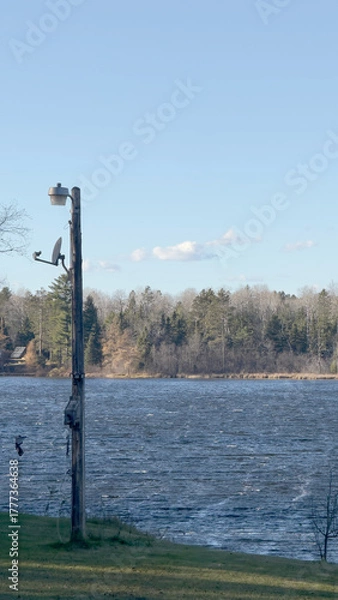 Fototapeta A lamp post by the lake in autumn