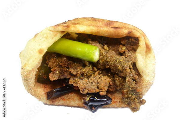 Obraz Deep fried beef liver slices, beef liver covered with wheat bran, (Kebda Bel Rada) which means Fried bran liver, served with parsley, green pepper, pickled eggplant and cucumber in Egyptian flat bread