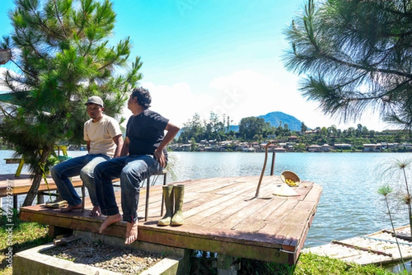 Fototapeta Hardworking Farmers Carefully Water Their Lush Cabbage Crops Under Hot Sun