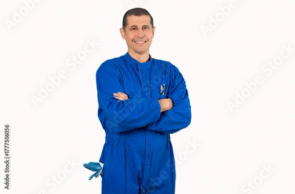 Fototapeta Portrait of confident mature mechanic in overalls with arm crossed and looking at camera isolated on white background