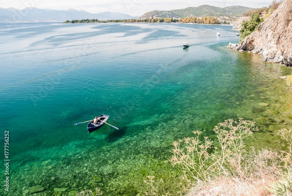 Obraz Man paddling in boat in calm Lake Ohrid, Macedonia