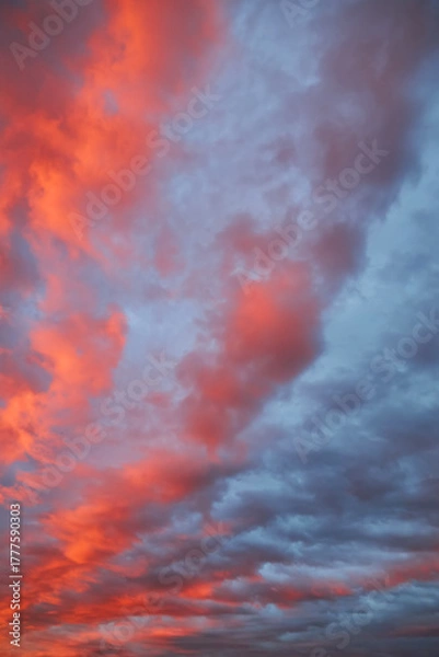 Fototapeta A dramatic sunset sky with a single fiery red cloud.
