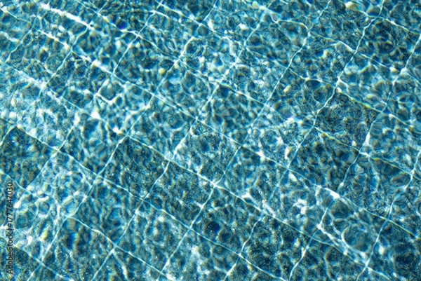 Fototapeta pool water abstract background with mosaic pattern. close up view of crystal clear turquoise water with ripples and wavy patterns