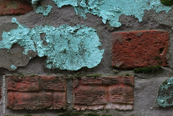 Fototapeta Background of a crumbling wall made of red clay brick and turquoise painted cement plaster
