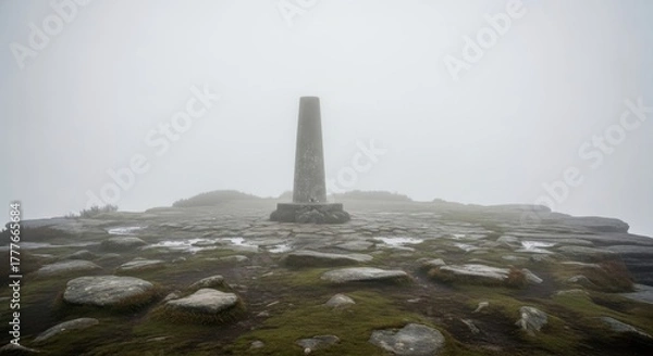 Obraz Misty Summit Marker: A Solitary Obelisk Amidst Enigmatic Weather