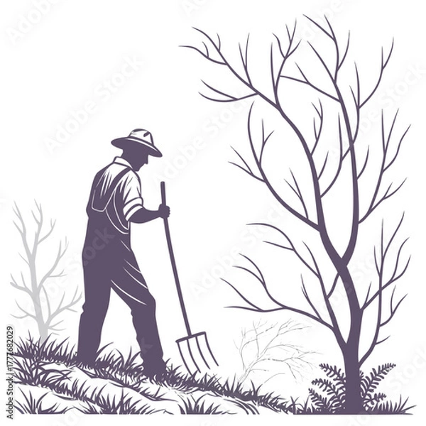 Obraz Silhouette of a farmer working the land with a pitchfork near bare trees