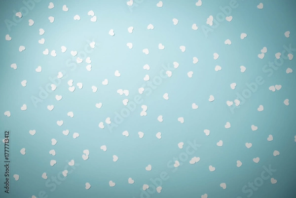 Obraz White heart shape confetti on a light blue background.