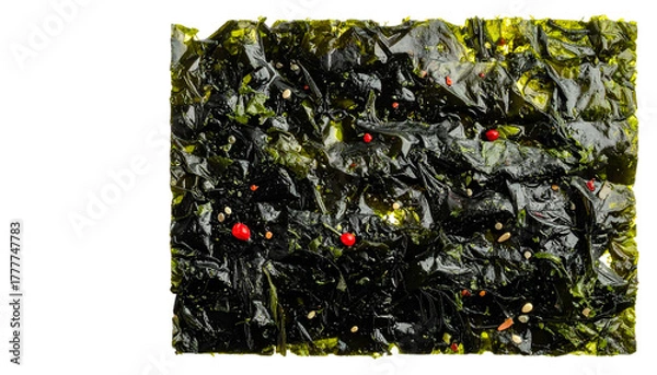 Obraz Crinkled seaweed snack with red & white bits on dark textured sheet