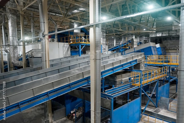 Obraz View of the conveyor and mechanical units for collecting and sorting at a large plant for processing household waste, an industrial view of modern ecology