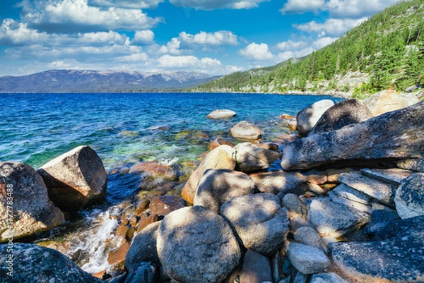 Fototapeta Lake Tahoe California USA view of clear turquoise water with granite rocks and pine forest along mountain shore under blue sky with clouds scenic summer landscape of Sierra Nevada nature