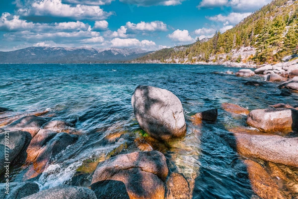 Fototapeta Lake Tahoe California USA view of clear turquoise water with granite rocks and pine forest along mountain shore under blue sky with clouds scenic summer landscape of Sierra Nevada nature