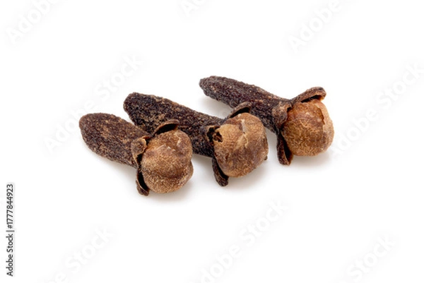 Fototapeta Three dried whole cloves isolated on white, aromatic spice closeup