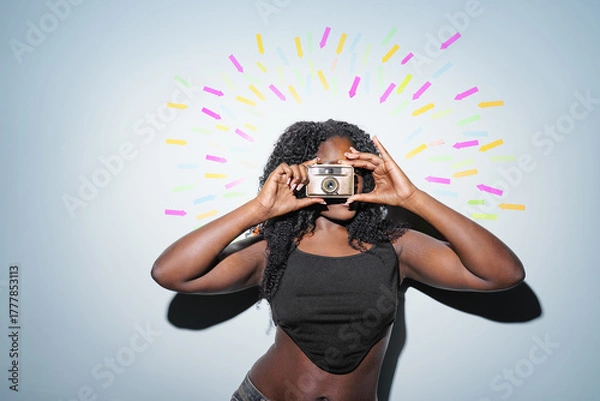 Fototapeta Portrait of a young woman with a retro camera at the center. Arrows in the background point towards the woman. social media, successful, communication concept.