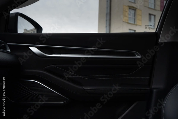 Fototapeta Interior door of a modern car. Front handle door panel with buttons of a car